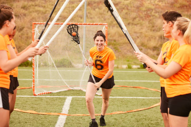 istock Unity and Support: Lacrosse Players Create Sticks Tunnel for Celebratory Run 1493125239