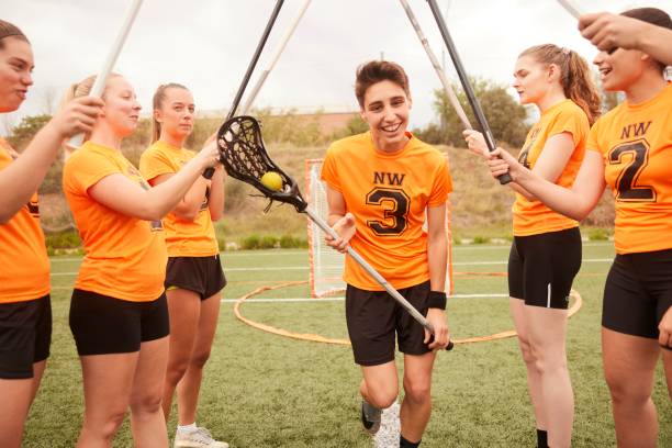 istock Path of Support: Lacrosse Players Form Stick Tunnel for Teammate 1493125248