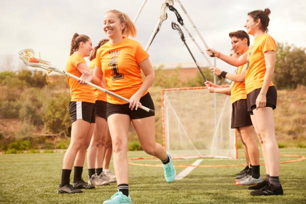 istock Victorious Welcome: Lacrosse Team Forms Sticks Tunnel to Celebrate Teammate 1493125256