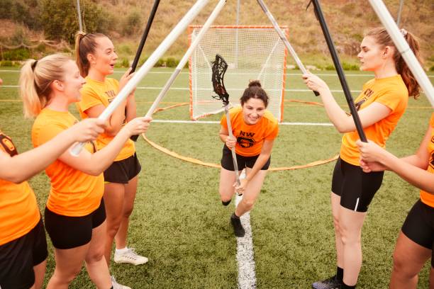istock Dynamic Dash: Female Lacrosse Player Charges through Stick Tunnel. 1493125261