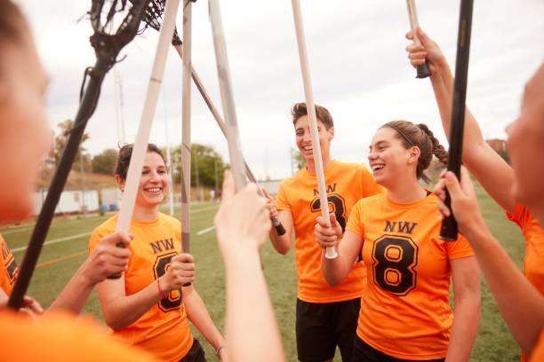 istock Vibrant Lacrosse Team Celebrates Victory with Uplifted Sticks 1493125287