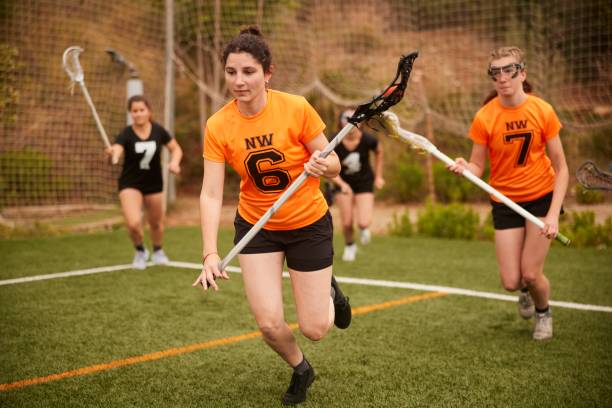 istock Determined Lacrosse Player Races with Precision, Expertly Carrying Stick and Ball 1493125288