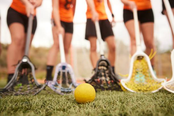 Close-Up Shot Reveals Lacrosse Players' Legs, Scoop, and Ball in  Detail. stock photo