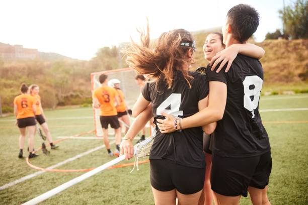 istock Unified Celebration: Lacrosse Players Rejoice with Enthusiastic Huddle. 1493125885