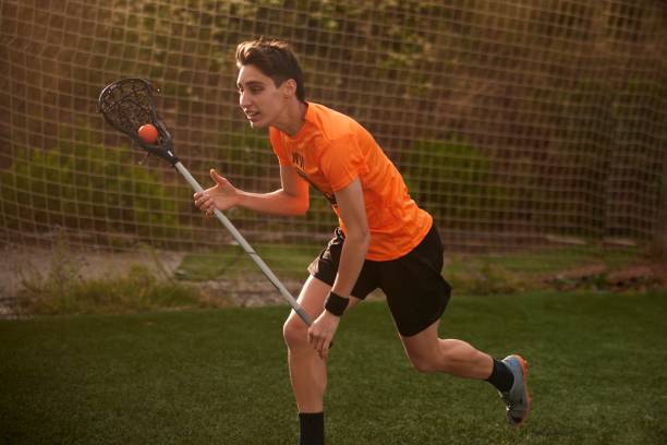 istock Focused Lacrosse Player Exhibits Precision and Speed in Intense Race 1493125952