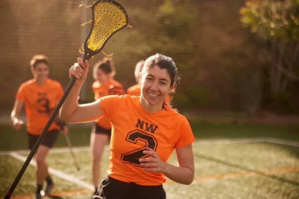 istock Victorious Lacrosse Attack Player Triumphantly Raises Stick After Scoring 1493125956