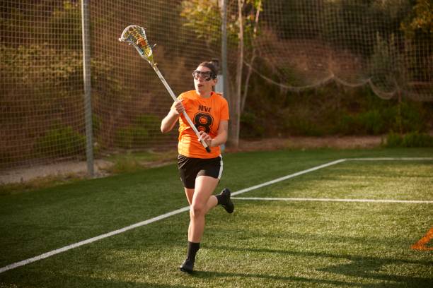 istock Speed and Precision: Female Lacrosse Athlete Executes Fluid Ball Cradle 1493125994