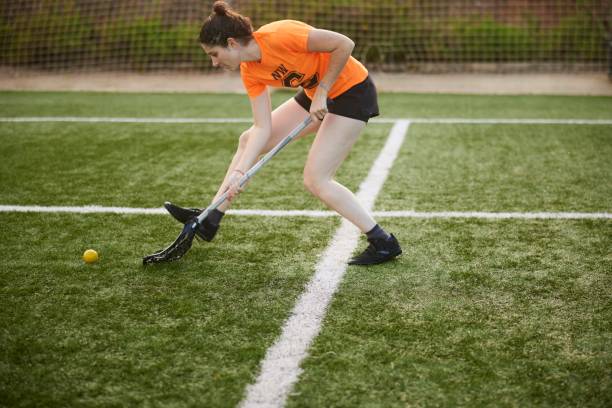 istock Focused Pursuit: Female Lacrosse Player Executes Swift Ground Ball Scoop Mid-Sprint. 1493126011