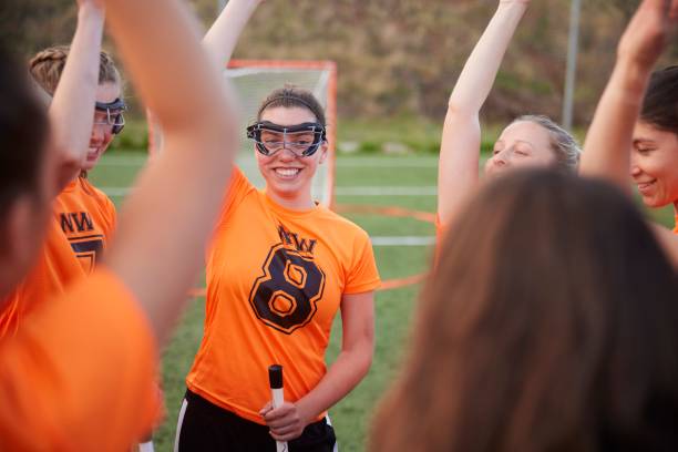 istock Circle of Unity: Female Lacrosse Team Raises Hands in Cheer. 1493126052