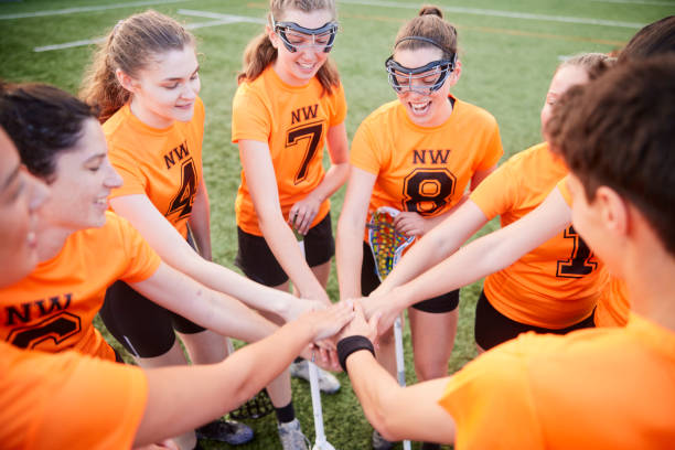 istock Circle of Unity: Lacrosse Players Stand in Motivational Gesture with Hands Joined