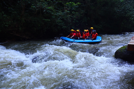 Bandung, Indonesia - May 11, 2023 : expressions of several rafting teams when going through a fast current