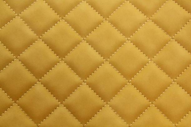istock Close-up texture of beige stitched threads leather with seam background. Rhombus pattern for interior car, sofa, wall covering, headboard 1493127153