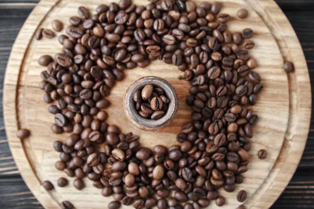istock coffee beans with clay pot on a wooden tray, dark background 1493130984