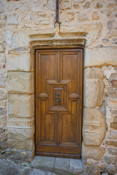 istock beautiful wooden door on a stone wall 1493131900