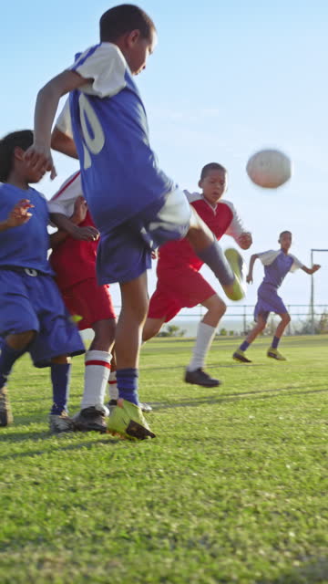 Playing soccer, field and children in a game for fitness, training and team tournament. Practice, competitive and athlete players and kids at a park to play football, sports and trial for a club