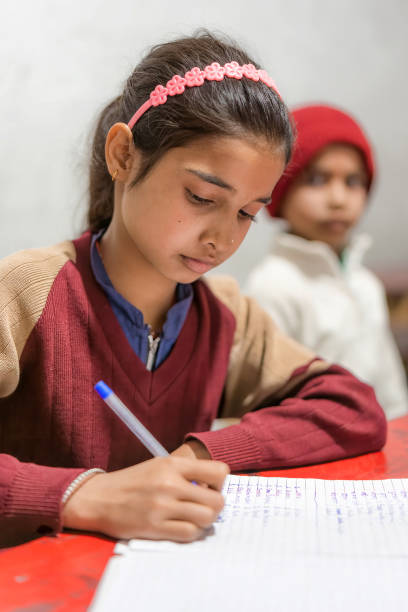 istock Indian Girl Studying, Writing on a Notepad in the Classroom at Elementary School, Learning and Education Concept 1493143354