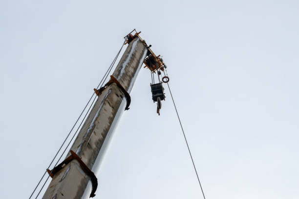 istock Unloading of building materials by crane at the construction site 1493144424