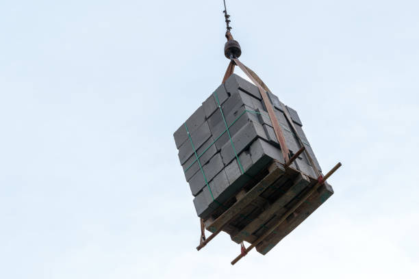 Unloading of building materials by crane at the construction site