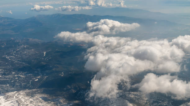 panorama view from the airplane window to mountains clouds and blue sky