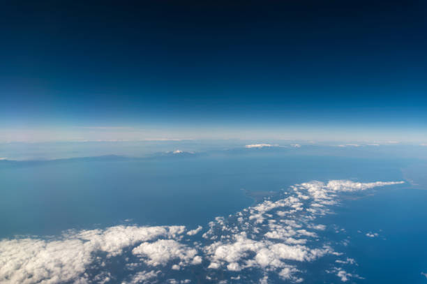 istock view from the airplane window to mountains clouds and blue sky 1493147466