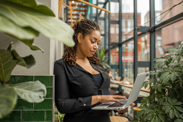 istock Beautiful diverse woman using technology in a green eco dutch cafe 1493147699