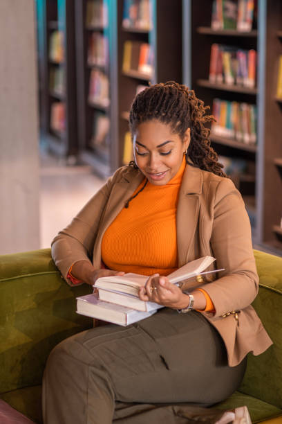 istock Beautiful ethnic black adult student studying in a public library 1493147923