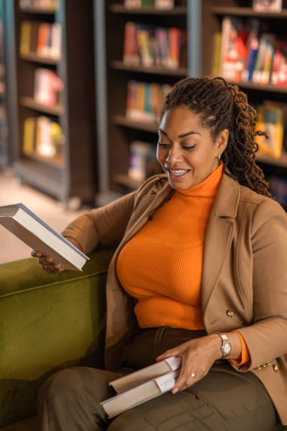 istock Beautiful ethnic black adult student studying in a public library 1493147930