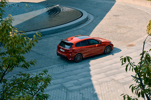 Red BMW M135i in front of the NOSPR concert hall. Top view. Model F40, produced from 2019. 306 HP engine, acceleration 0-100 km-h - 4.8 s Katowice, Poland- 09.16.2020