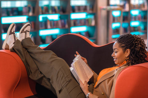 istock Beautiful ethnic black adult student studying in a public library 1493148214