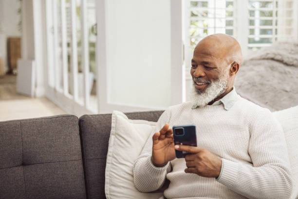 istock Handsome man relaxing in the sofa with smartphone at home 1493149876