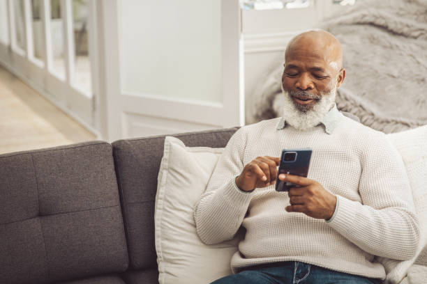 istock Handsome man relaxing in the sofa with smartphone at home 1493150226