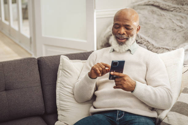 istock Handsome man relaxing in the sofa with smartphone at home 1493150235