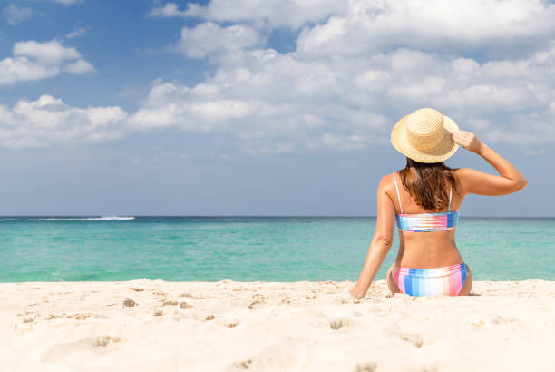 istock Woman sitting on the sea beach 1493150252