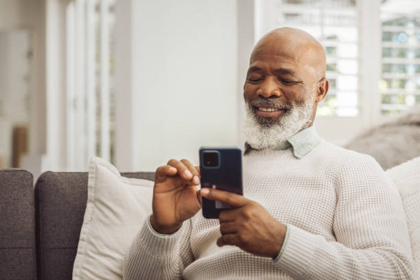 istock Handsome man relaxing in the sofa with smartphone at home 1493150441