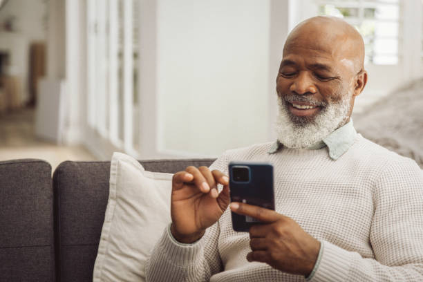 istock Handsome man relaxing in the sofa with smartphone at home 1493150453