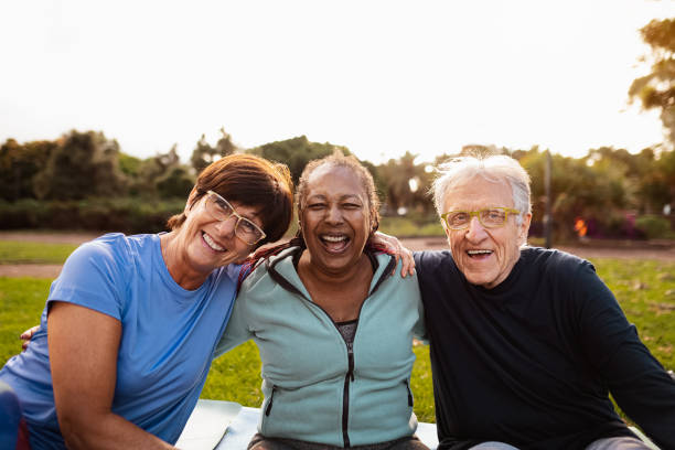 istock Happy multiracial senior friends having fun smiling at the camera after training activities in the park 1493156264