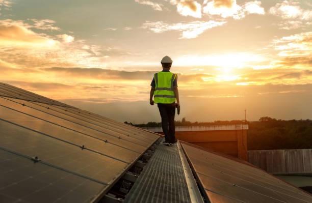 istock Engineer working setup Solar panel at the roof top. Engineer or worker work on solar panels or solar cells on the roof of business building 1493157412