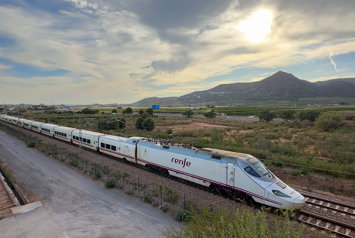 High-speed AVE train in motion on Valencia high-speed railway. Spanish Railways. RENFE SNCF - Spanish National Rail Network. Talgo 250 Dual train. April 12, 2023, Spain, Valencia region.