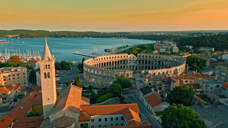 AERIAL view Sunrise Scene of Pula Arena, A Roman Amphitheatre with Adriatic Sea in Pula. Istria, Croatia