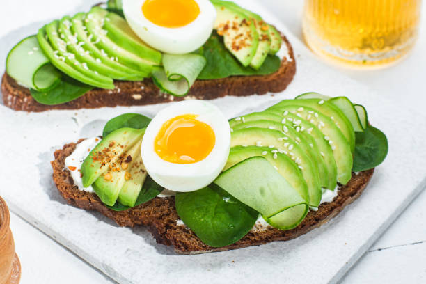 istock Sandwich with cream cheese, avocado and boiled egg on a white background 1493159608