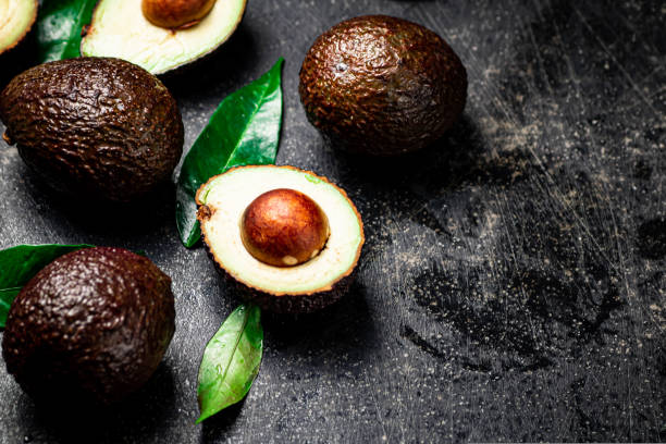 istock Fresh avocado with leaves. On a black background. 1493162545