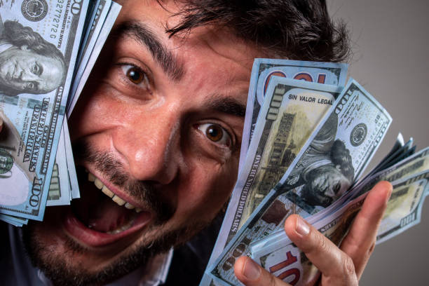 istock Happy man with many dollars in his hands. 1493172586