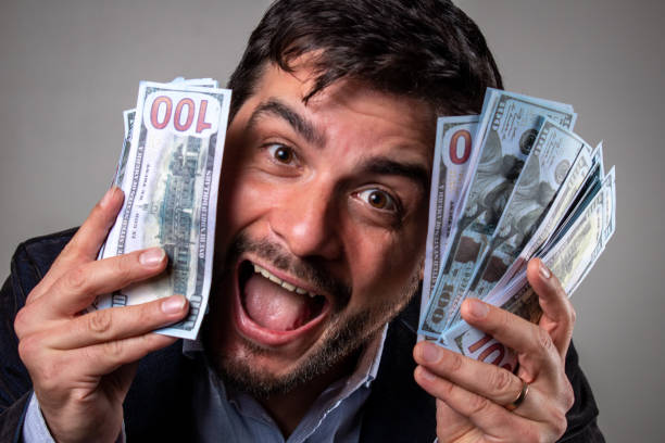 istock Happy man with many dollars in his hands. 1493172639