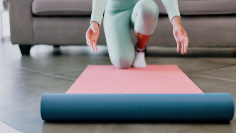 Fitness, yoga and woman rolling mat on floor for workout, wellness and healthy morning exercise at home. Closeup female prepare to start pilates training in living room, house and sports for balance