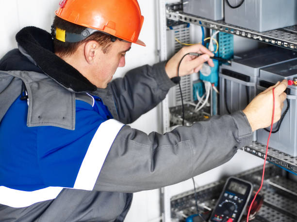istock Electrician checks battery capacity with multimeter. authentic workflow. 1493173948