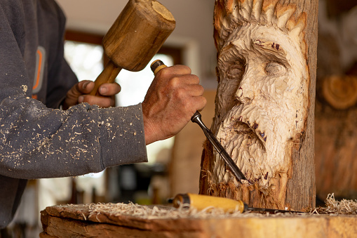 close up of carving a wood sculpture by hand