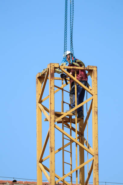 istock Construction worker on the part of a tower crane 1493179131