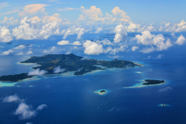 Weno / Moen island, Chuuk / Truk State, Federated States of Micronesia (FSM): main island of Chuuk state - Chuuk lagoon, reef, coast and mountains. The island is located in Chuuk Atoll, Chuuk lagoon. Weno is home to the state's only airport, Chuuk Airport, on the right. In the foreground Fono Island (right) and Pisiwe Island (center).