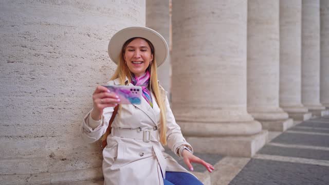 Woman having video call from St. Peter's Square in Vatican City