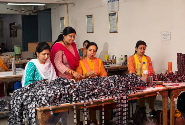 istock Manager inspecting workers cutting garments at textile factory 1493187754